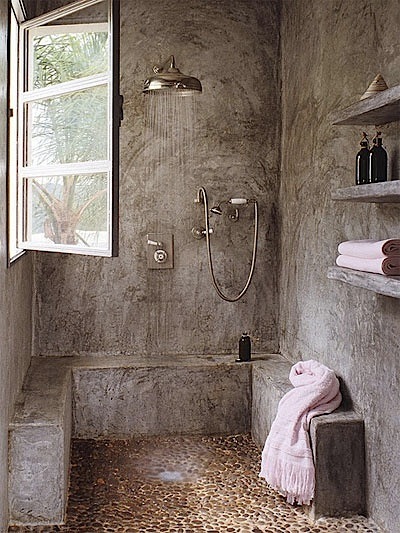 bathroom with concrete walls and raw floor