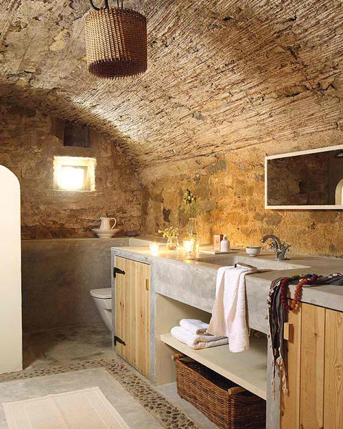 concrete batrhroom with raw stone and wood