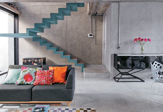 concrete living room with colored stairs