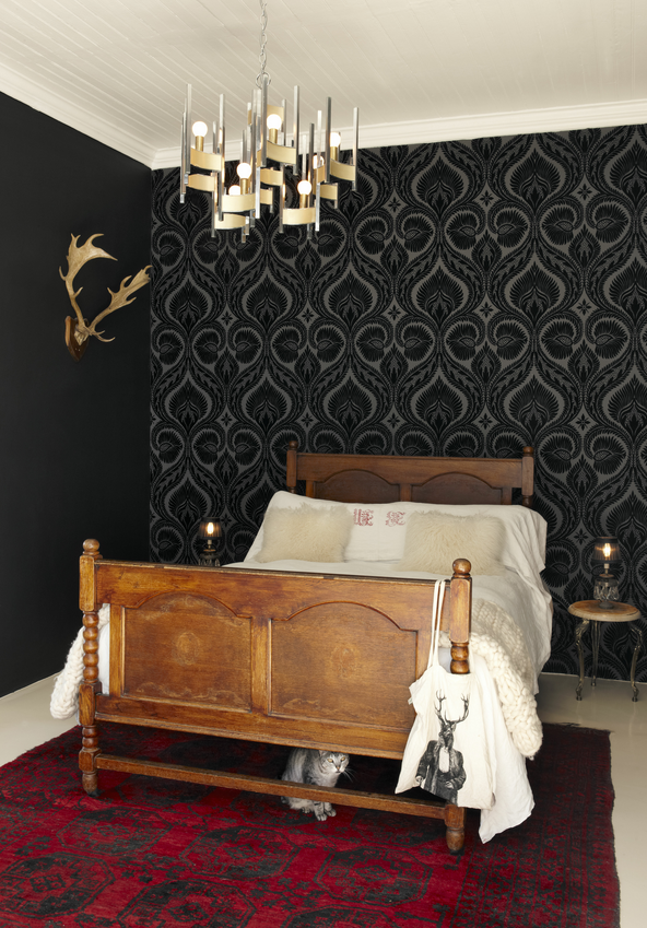 bedroom with wood bed black wall and wallpaper midcentury lighting