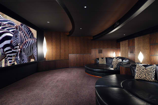 contemporary home theater room with black modern leather circular sofas