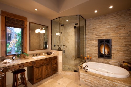 bathroom design with raw stone wall and fireplace