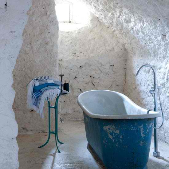 white stone bathroom with free standing bathtub