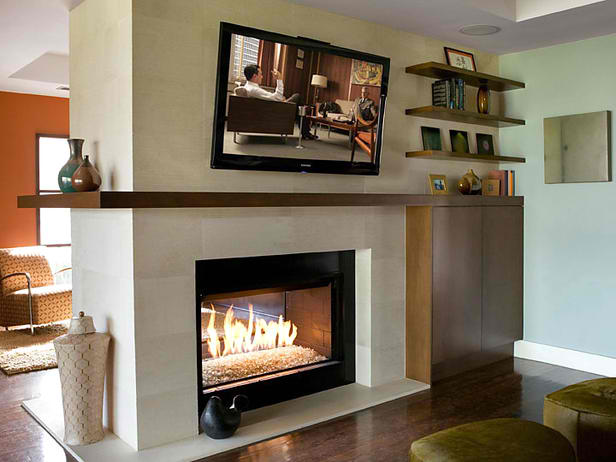 tv above Textured limestone fireplace