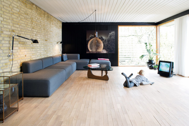 minimalist living room with black and brick walls