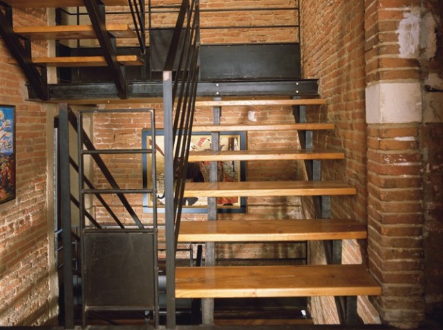 stairs with brick walls