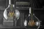 chandelier suspended inside a glass lightbulb