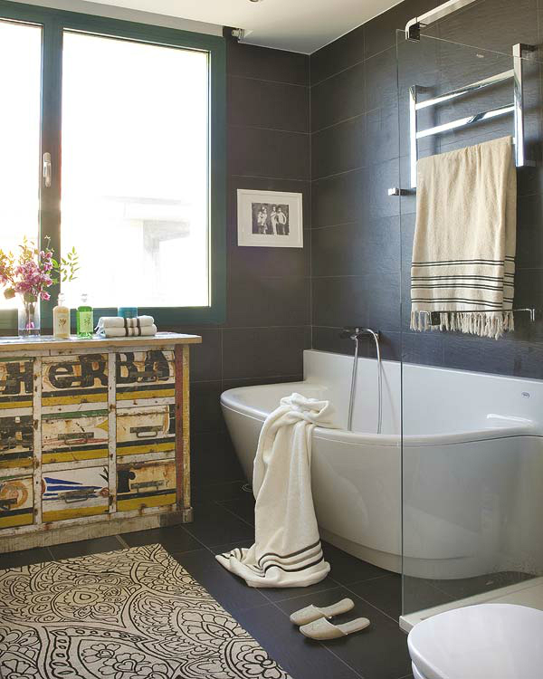 modern bathroom with antique furniture and black tiles