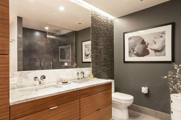 gray contemporary bathroom with wood furniture and art