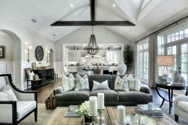 room full of furniture and exposed beams