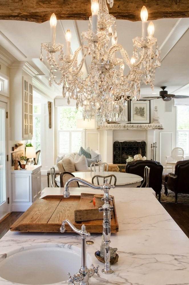 timeless kitchen with Carrara Marble countertop and crystal chandelier