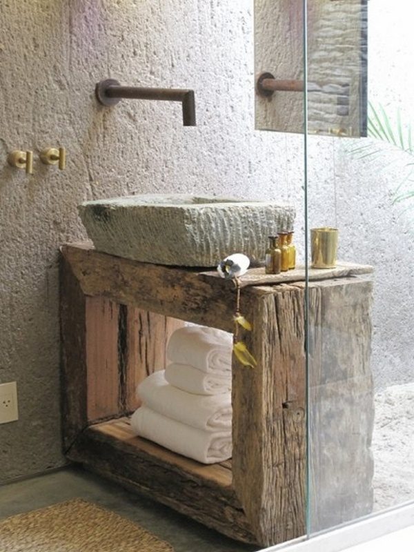 Wabi Sabi bathroom with stone sink, rough wood vanity, and industrial hardware