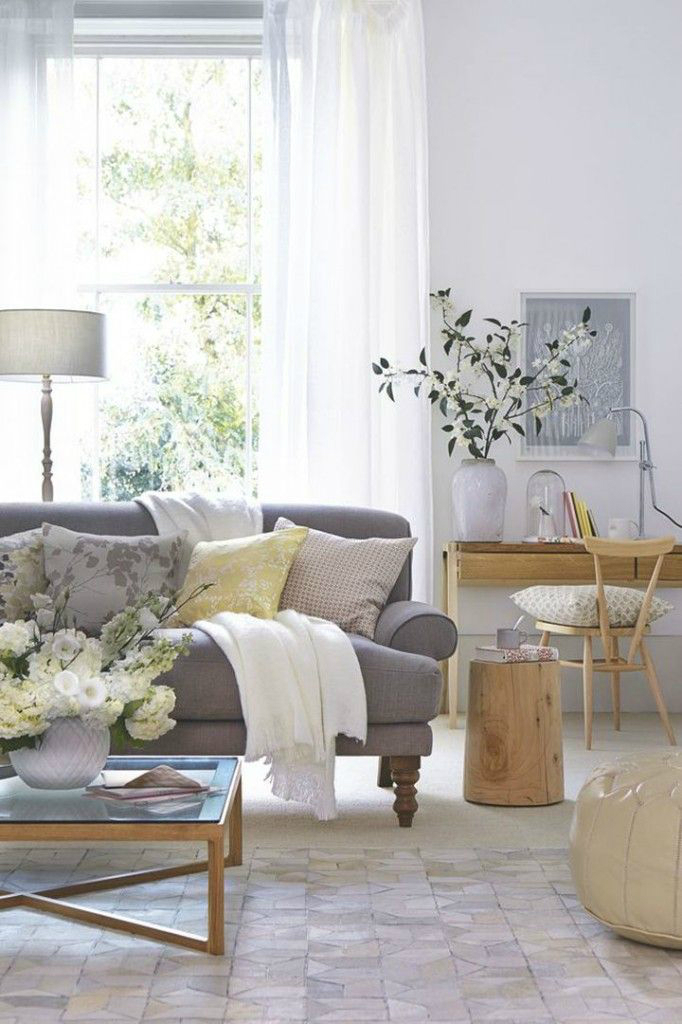 dark colored gray sofa with light neutral pillows
