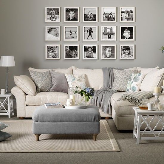 gray and white living room with family photo frames on the wall