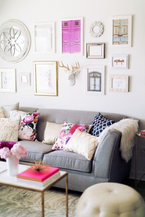 contemporary living room with gray sofa and pink touches