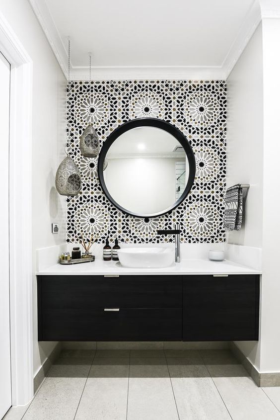 black and white bathroom with  round mirror