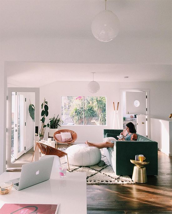 fresh lightful living room with green sofa