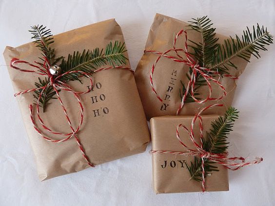 simple Christmas gift wrap: brown paper, stamps, evergreen, bakery twine