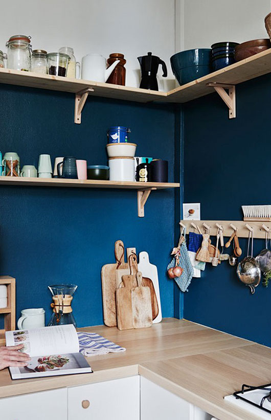 blue wall and open shelves