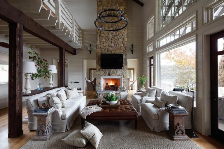 country formal high ceiling living room with stone fireplace 