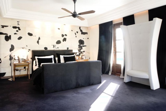 modern black and white bedroom with cow wall