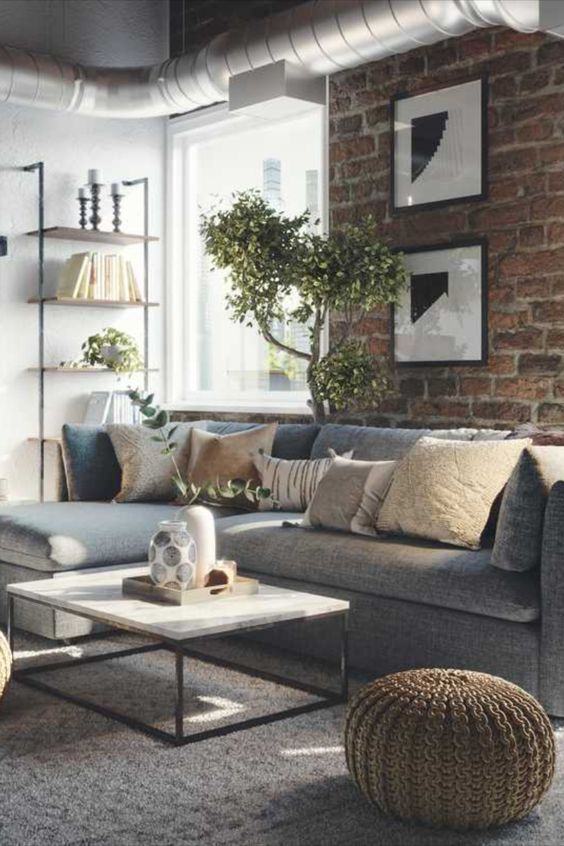 neautral industrial chic living room with brick wall and plants