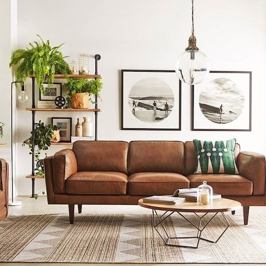 modern mid-century industrial living room with camel leather sofa and indorr plants