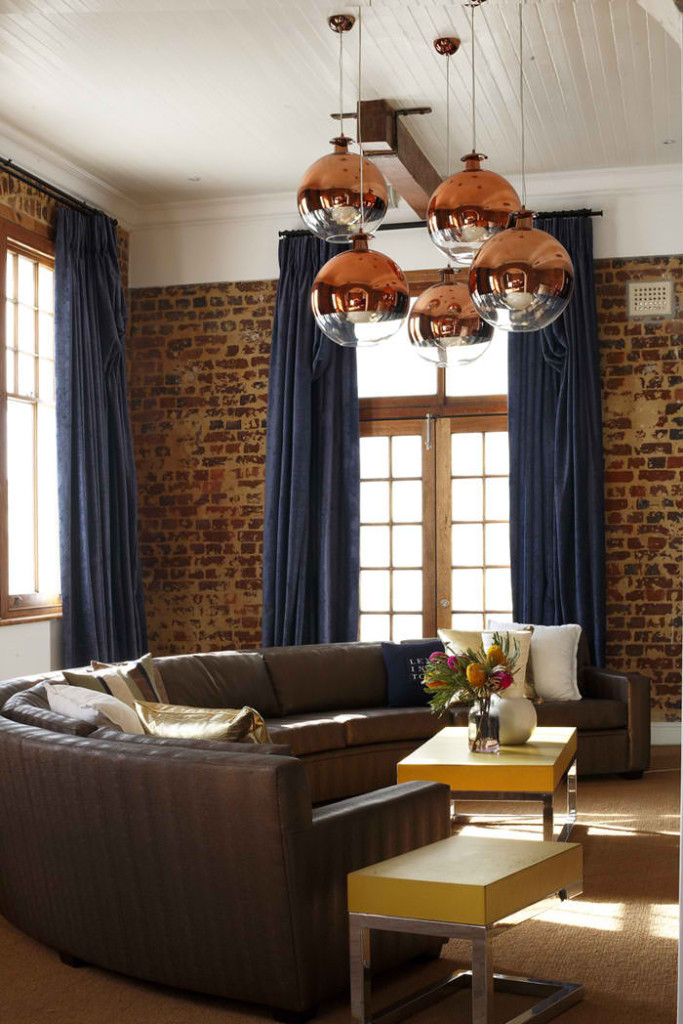 living room 2 with old raw brick wall and dark blue curtains