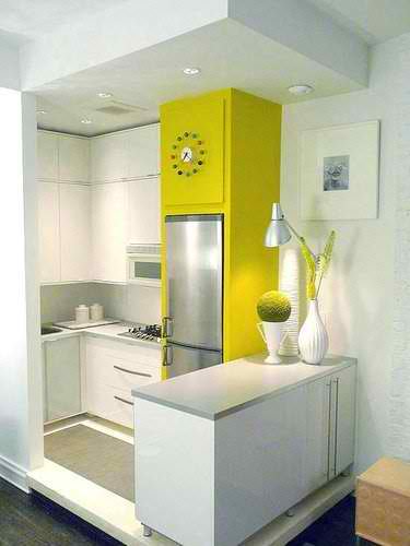small kitchen with white cabinets and lime wall