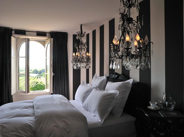 black and white bedroom with crystal hang chandeliers