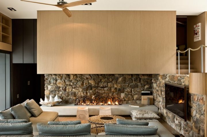 contemporary living room with stone and wood fireplace