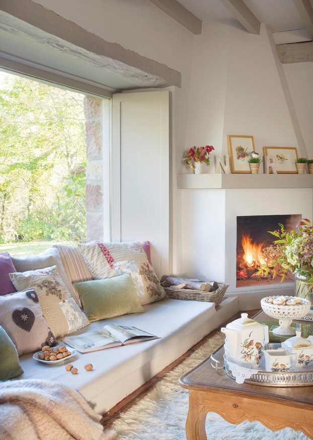 cozy living room with fireplace and low sofa under window