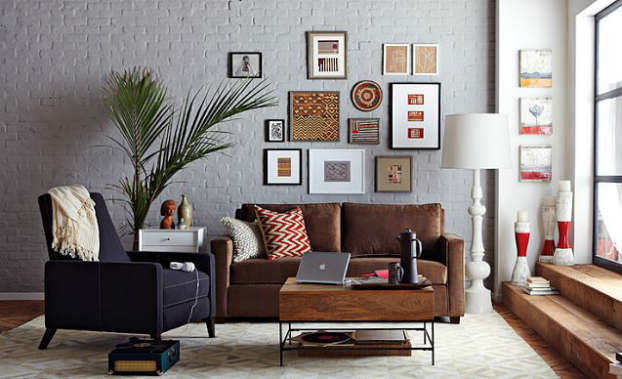 multi fuctional space with brown couch and black armchair