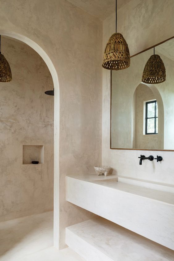 bathroom walls and integral vanity are also plastered in chukum stucco; the mortar on the countertop is a classical design sourced from a Mayan village