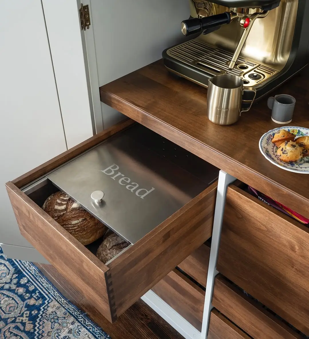 Walnut storage drawers inside a custom home coffee bar with organized kitchen storage