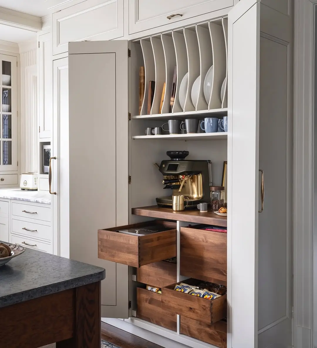 Built-in kitchen coffee station with walnut drawers, hidden storage, and espresso machine