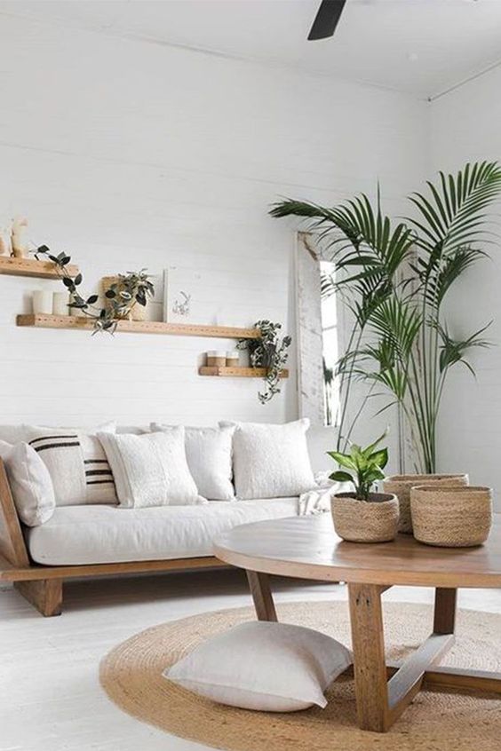 small white living room with wood floating shelves