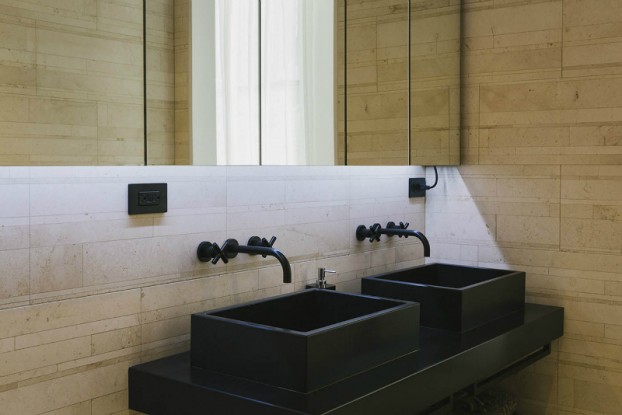 contemporary bathroom with double black sinks and faucets