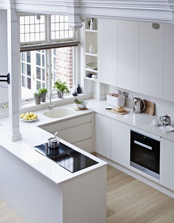 open plan all white kitchen with corian kitchen counter top