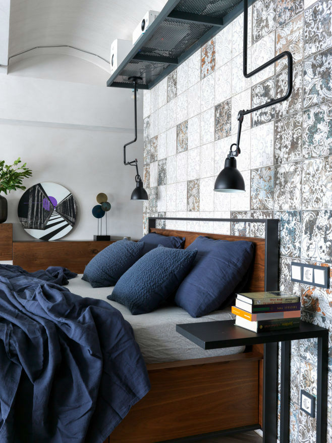 industrial style loft bedroom with navy blue sheets
