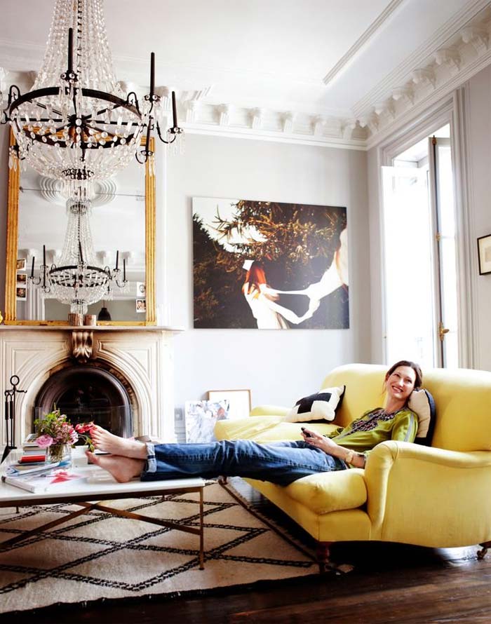woman sitting on yellow sofa
