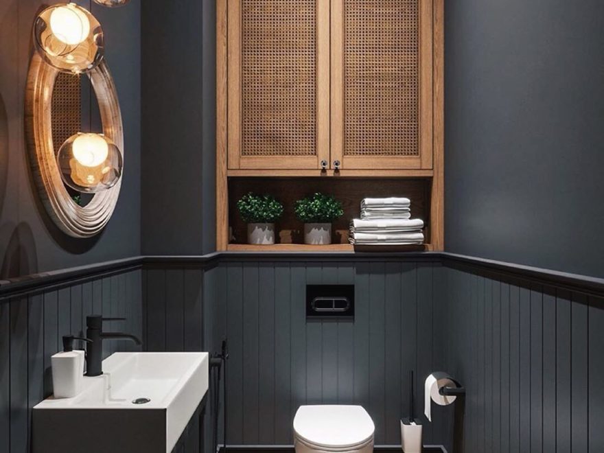 small black bathroom with wood furniture