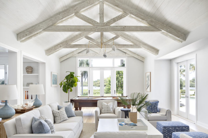 exposed beams in home decor with blue pillows and white sofas