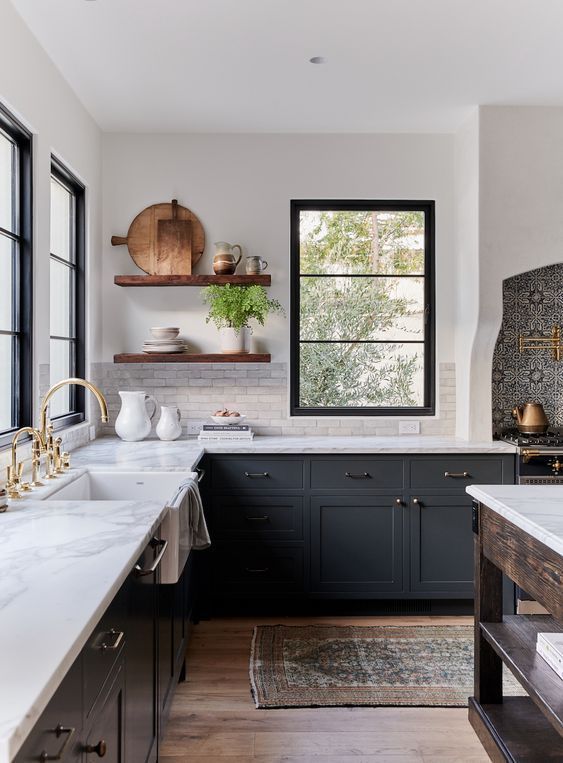 dark gray kitchen cabinets with white marble countertop and wood open shelves