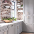 dove gray kitchen cabinets with brick wall