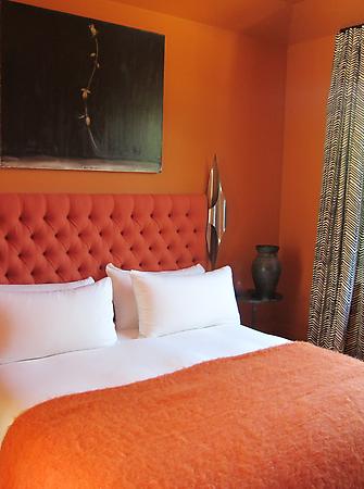 orange bedroom with oragne walls and headboard