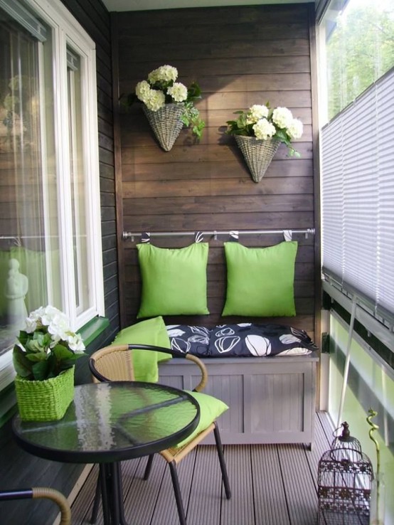 green pillows and some flowers in balcony