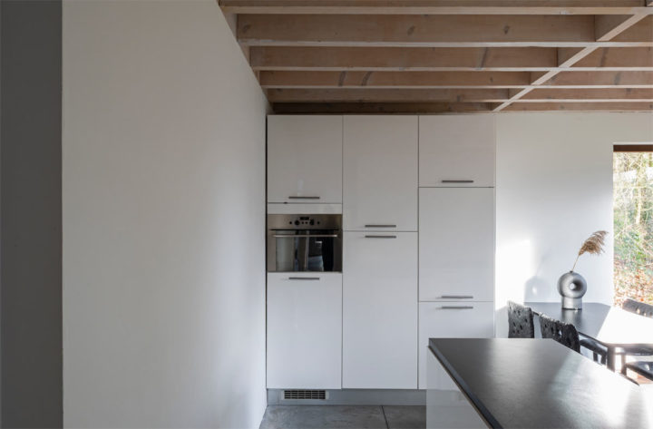 minimalist white kitchen floor to ceiling cabinets