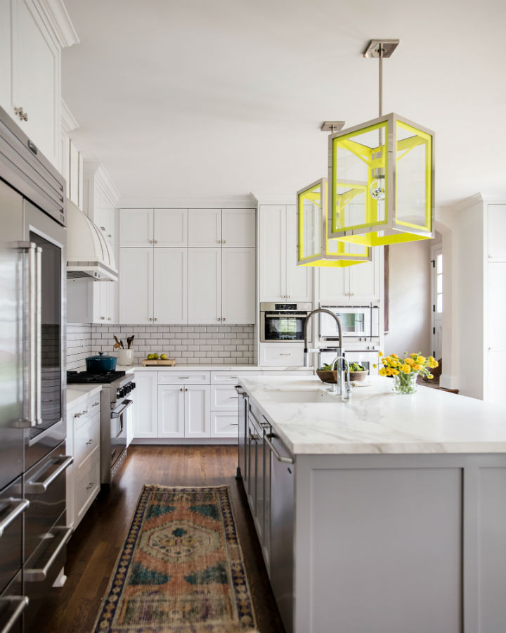 grey and white kitchen with island and flu yellow lights
