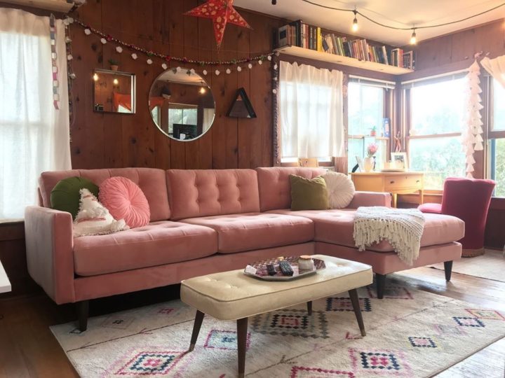 modern-pink-tufted-velvesectional-dofa-with-wood-paneled-wall